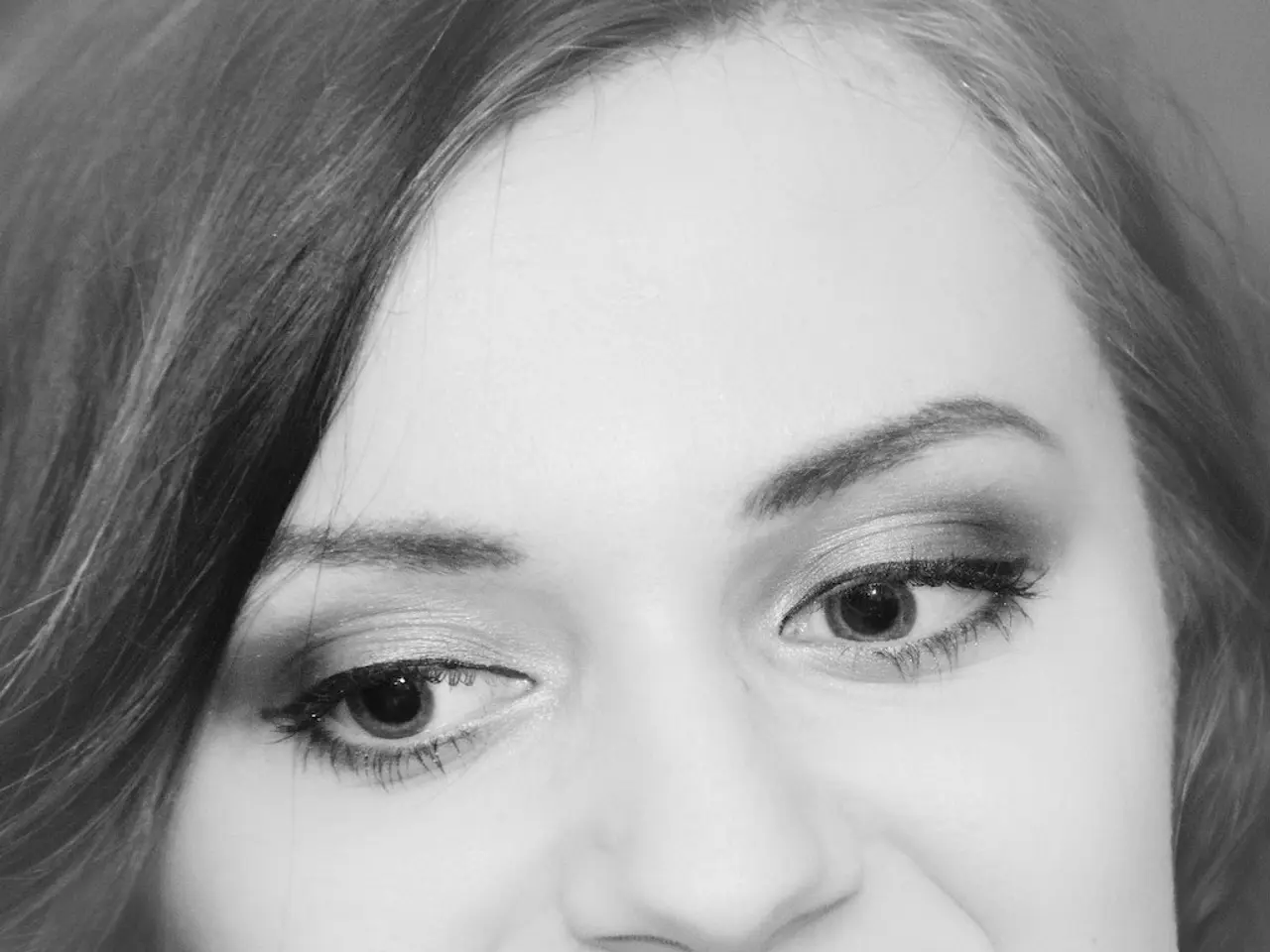 This is a zoomed in picture. In the foreground we can see the face of a person consists of eyes,...