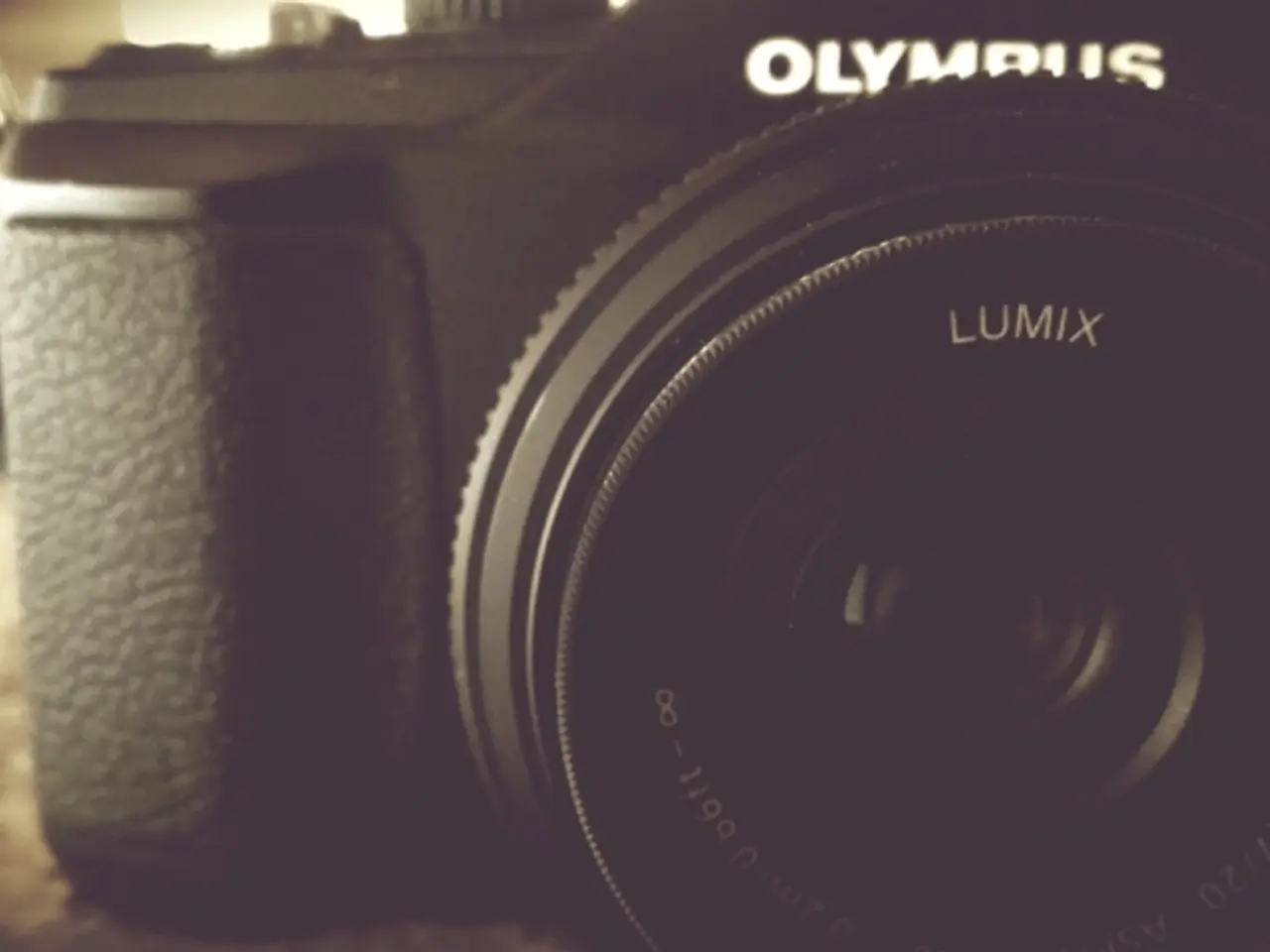 In this image, there is a black color camera, on that camera there is LUMIX is written.