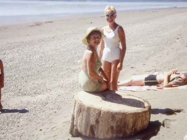 As we can see in the image there are few people and in the background there is water. In the front...