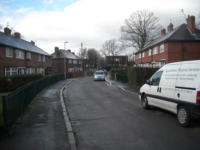 There is a road. On the road there are many vehicles. On the sides of the road there are sidewalks....