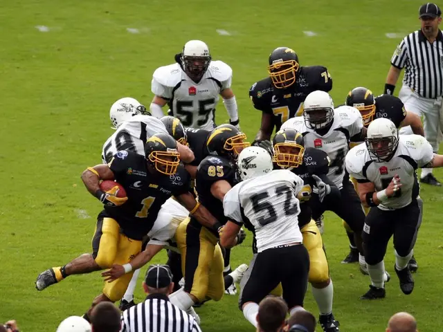 Here, we can see some people playing the game and they are wearing helmets, there is green grass on...