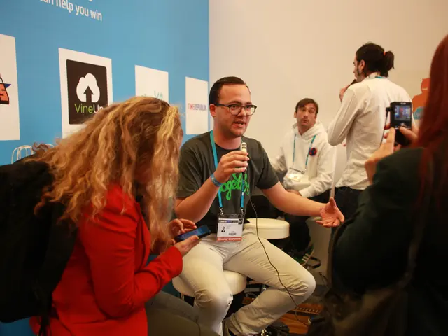 In this picture there is an interview going on, we can see people holding mic and camera. In the...