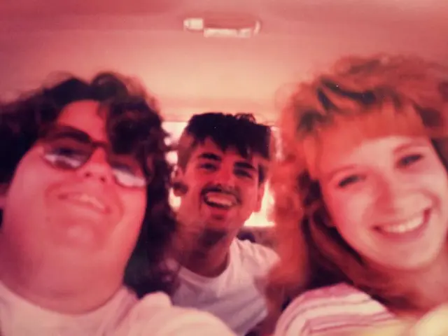 In this picture we can see 3 people looking and laughing at someone.