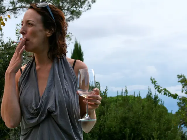 In the picture of a woman is smoking cigar, she is wearing goggles, she is holding class in a hand,...